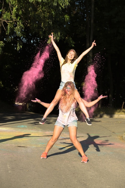 Due adorabili amiche che si divertono con la polvere di Holi che esplode