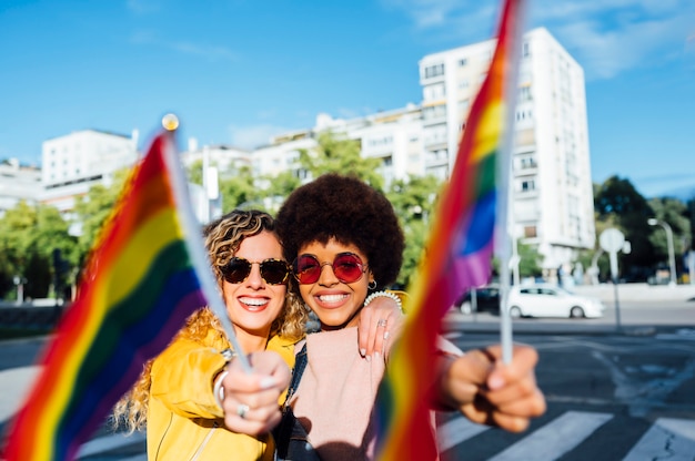 Due amiche in giro per la città agitando LGBT