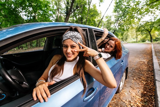 Due amiche scherzano e ridono insieme in macchina