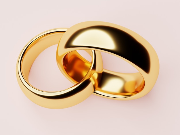 Due anelli di nozze d'oro giacciono l'uno nell'altro. Concetto di amore