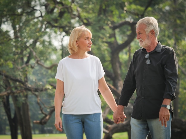 Due anziani pensionati felici L&#39;uomo e la donna stanno camminando e parlando nel parco