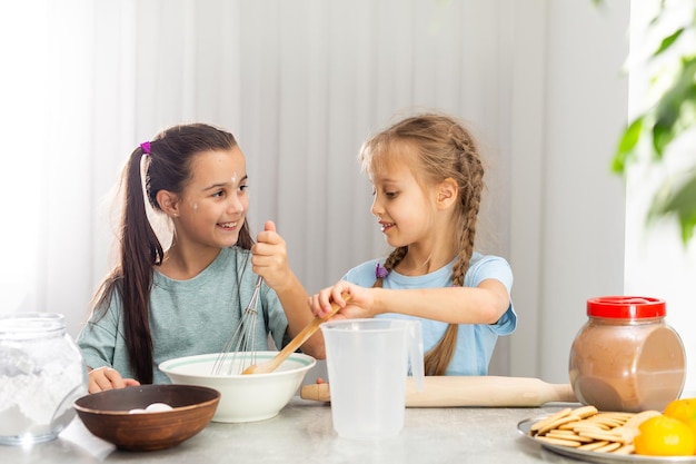 due bambine preparano i biscotti di Natale in cucina