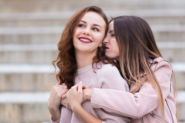 Due belle ragazze che posano sulla strada