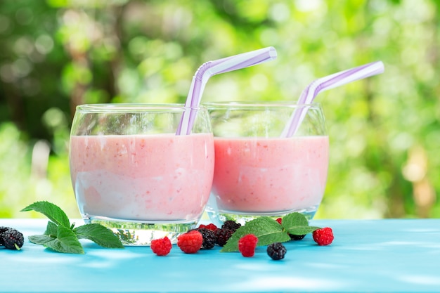 Due bicchieri rotondi di frullato di bacche o yogurt con ras sparsi