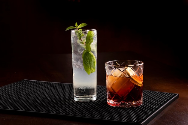 Due cocktail bartender mojito e negroni nell'angolo di supporto professionale