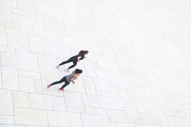 Due donne che corrono nella città, vista aerea