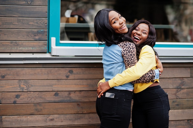 Due giovani amiche afroamericane del college si abbracciano.