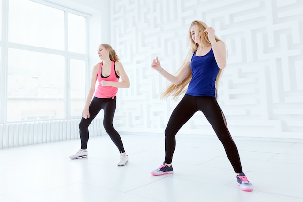 Due giovani donne in forma che fanno un allenamento di danza fitness