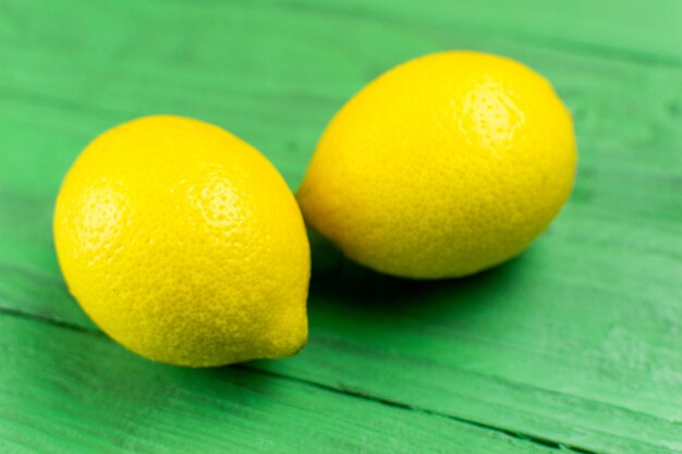 Due limoni gialli su fondo di legno verde