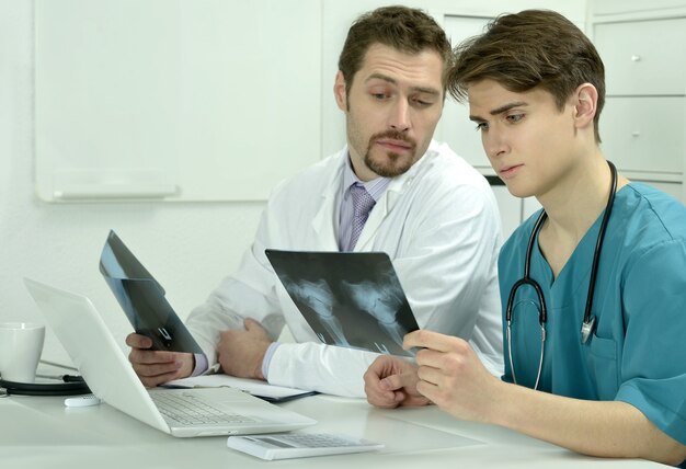 Due medici maschi in studio medico con raggi X