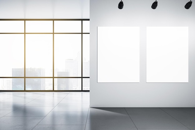 Due poster bianchi vuoti con posto per il tuo logo o testo sulla parete chiara in un ufficio vuoto illuminato dal sole con pavimento grigio e vista dei grattacieli della città dalla finestra panoramica Rendering 3D mock up