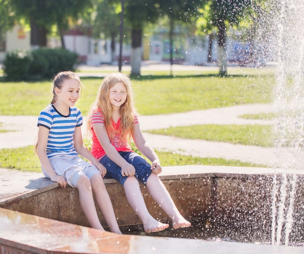 Due ragazze felici alla fontana