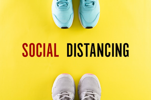 Due scarpe e testo inglese Social Distancing