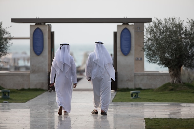 due uomini arabi che camminano in città