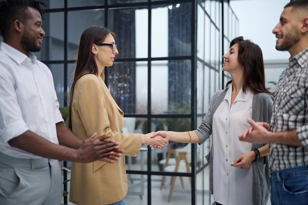 Due uomini d'affari professionisti si stringono la mano nella hall di un ufficio