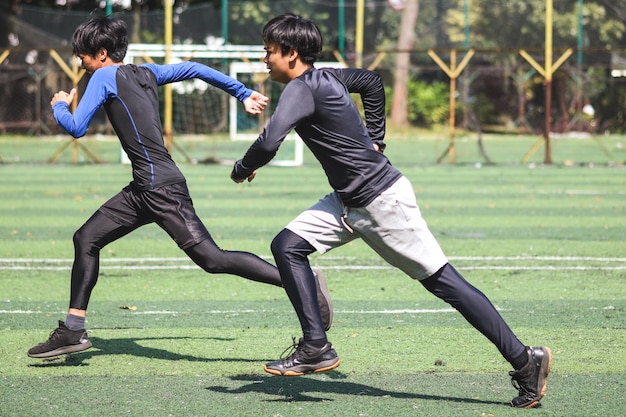 Due uomini sportivi che corrono Vista laterale dell'uomo attivo che si allena nel parco