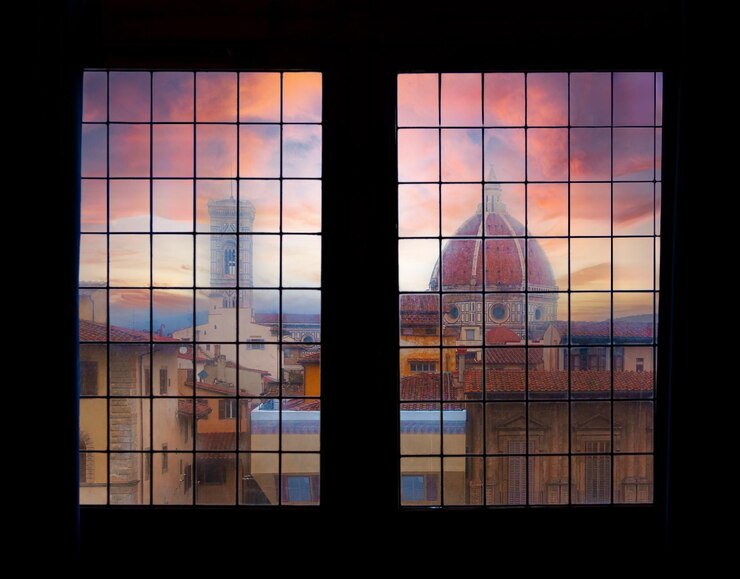 Foto duomo di firenze al tramonto da una finestra del palazzo vecchio
