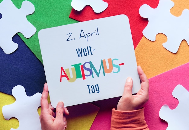 e tiene una pagina con testo in tedesco che significa 2 aprile Giornata mondiale della consapevolezza sull'autismo
