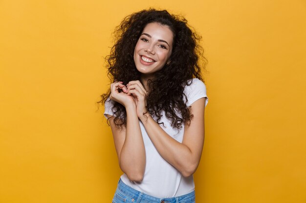 Eccitato giovane donna carina in posa isolata su giallo.