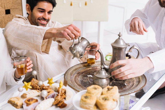 Eid al-fitr concept con cibo arabo e amici