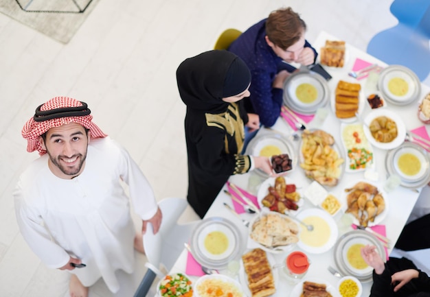 Eid Mubarak Famiglia musulmana con cena Iftar Mangiare cibo tradizionale durante il mese di festa del Ramadan a casa. La famiglia islamica islamica che mangia e beve halal