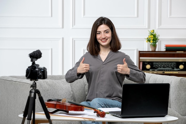 Elearning giovane bella ragazza carina a distanza a casa dando lezioni di violino