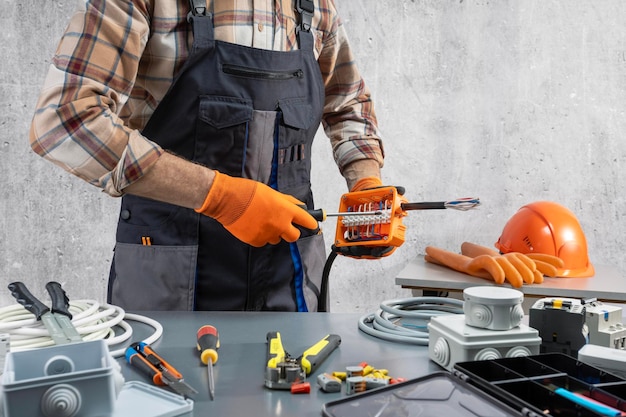 electrician working with electrical cable and electrical equipment