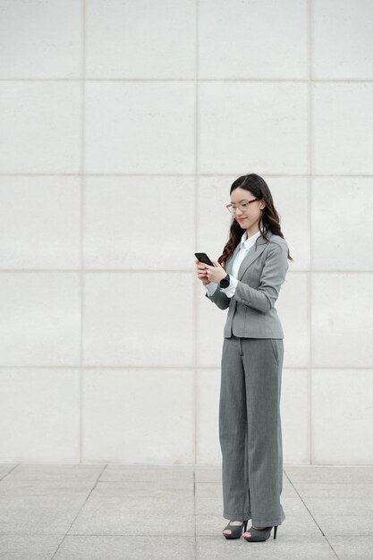 Elegante donna d'affari che controlla il telefono