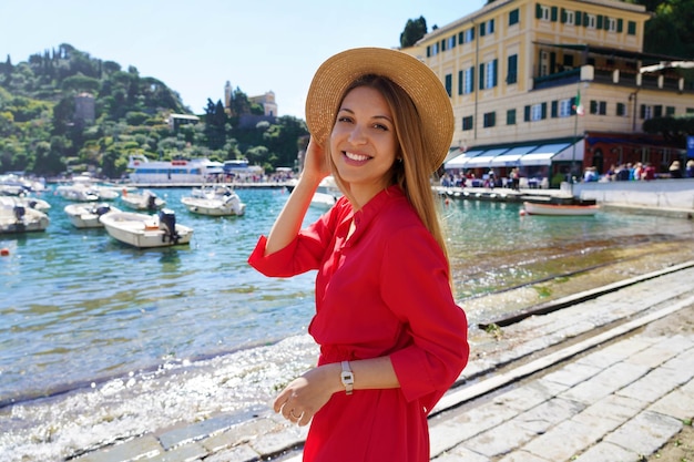 Elegante donna in abito rosso e cappello a Portofino Liguria Italia