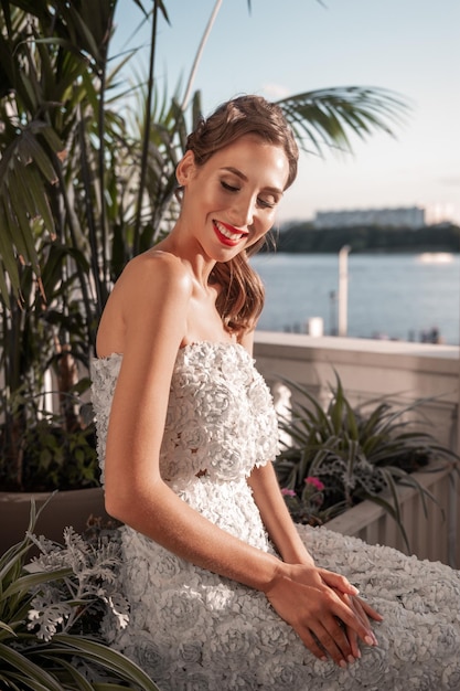 Elegante sposa in abito di taffetà azzurro e decorata con fiori fatti a mano