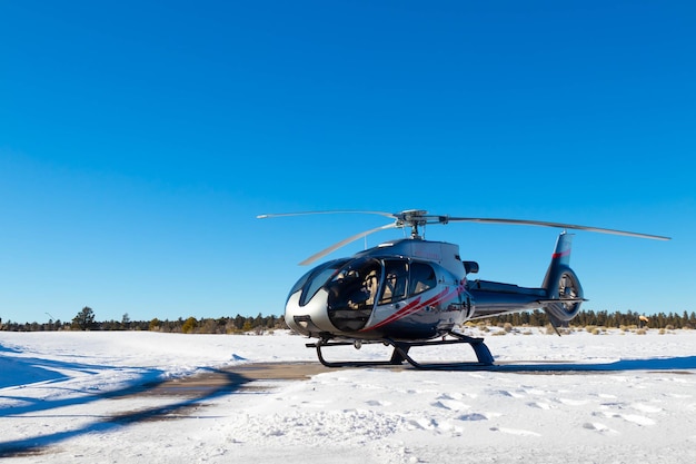 Elicottero isolato nel paesaggio innevato con cielo azzurro