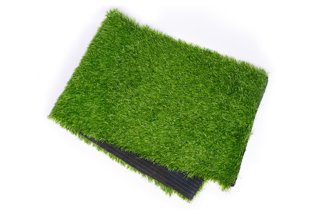 Erba artificiale per campi sportivi, erba di plastica verde su sfondo bianco.