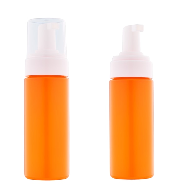 Erogatore di plastica arancione per crema o gel isolato su sfondo bianco. Dispenser per creme, zuppe, schiume e altri cosmetici con coperchio e senza.