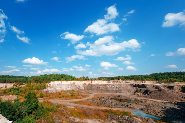 Escavatore e autocarri con cassone ribaltabile minerario pesante in una cava di calcare