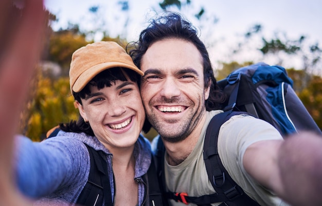 Escursionismo selfie e ritratto di coppia in montagna per vacanze avventurose e libertà all'aperto Incontri di viaggio e uomo e donna felici sorridono per foto per esplorare il trekking e lo zaino in spalla nella natura