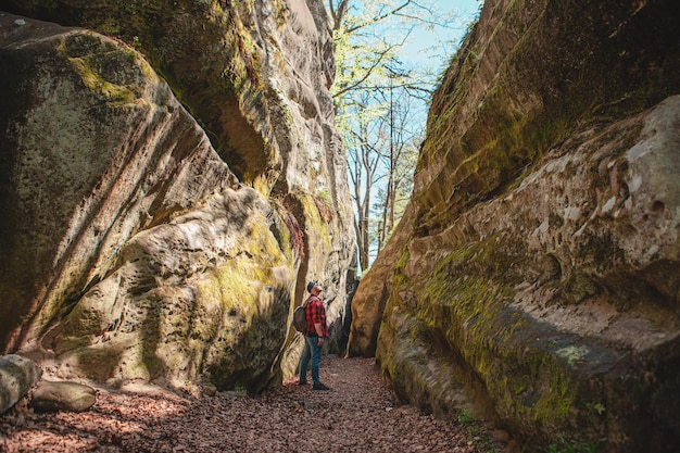 Escursionista uomo con zaino a piedi dal sentiero nel canyon