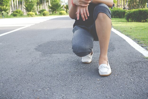 Esercizio di riscaldamento della ragazza prima di correre al parco mattutino.