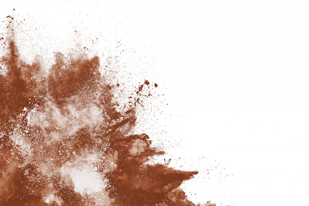 Esplosione di polvere di colore marrone su sfondo bianco.