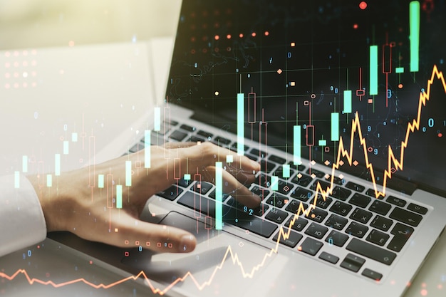 Esposizione multipla del grafico finanziario creativo astratto con digitazione a mano sul computer portatile su sfondo forex e concetto di investimento