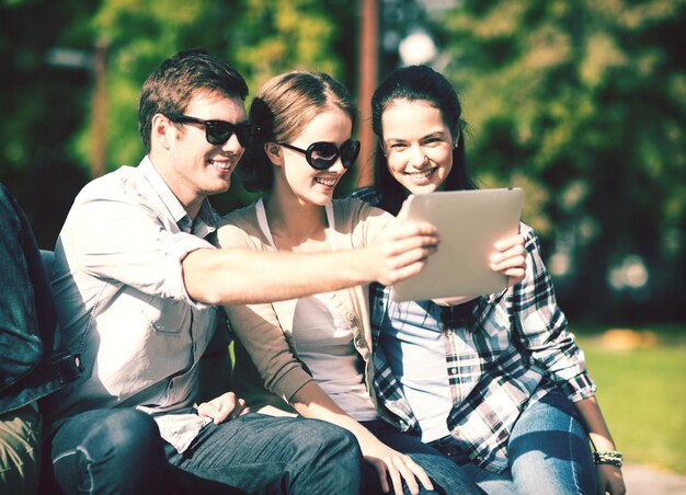 estate, internet, social network e concetto di adolescente - gruppo di adolescenti che scattano foto con tablet pc all'esterno