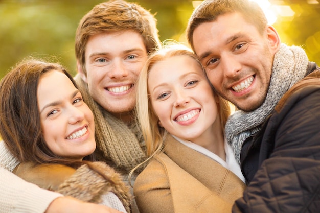 estate, vacanze, vacanze, concetto di persone felici - gruppo di amici o coppie che si divertono nel parco autunnale