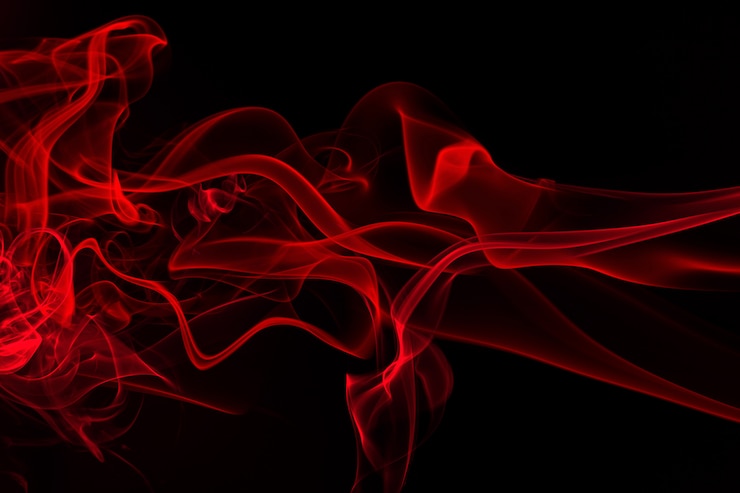 Estratto rosso del fumo su fondo nero. fuoco