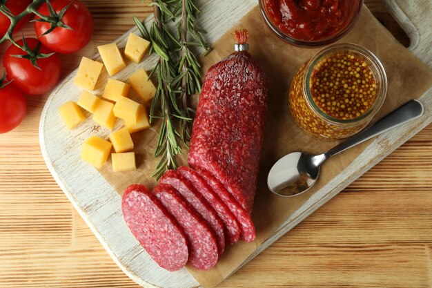 ÃƒÂ Ã‚Â¡oncept di cibo gustoso con salame su sfondo di legno