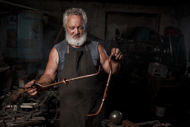 Fabbro che prepara lavorare metallo sull'incudine