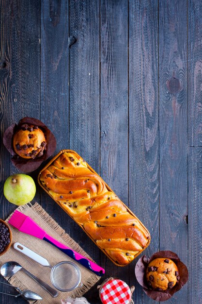 Faccia colazione con differenti pasticcini e frutti su un di legno