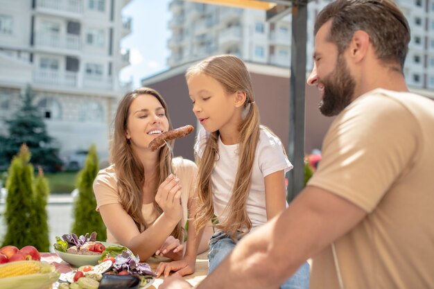 Famiglia a cena insieme all'aperto