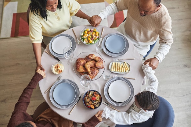 Famiglia africana che prega prima di cena