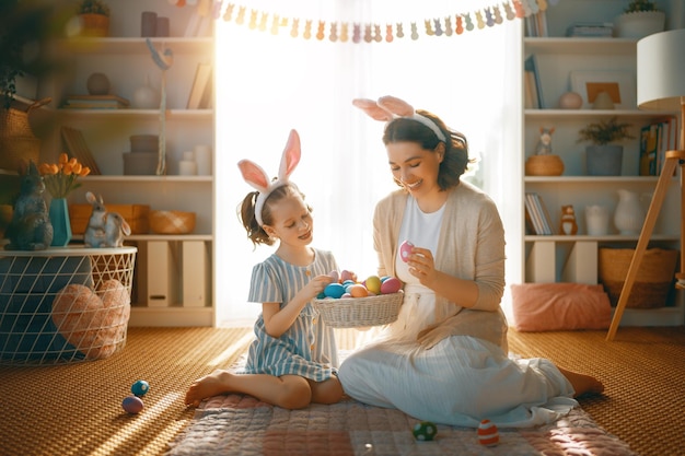 Famiglia che celebra la Pasqua Cute bambina indossa orecchie da coniglio