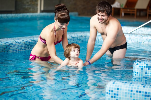 Famiglia che nuota in piscina.