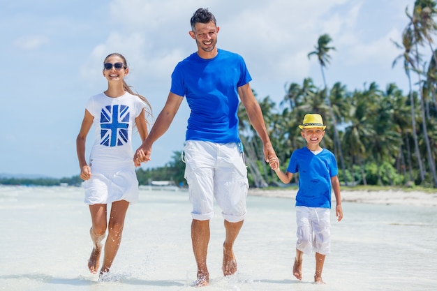 Famiglia di tre persone - padre con suo figlio che si diverte in spiaggia